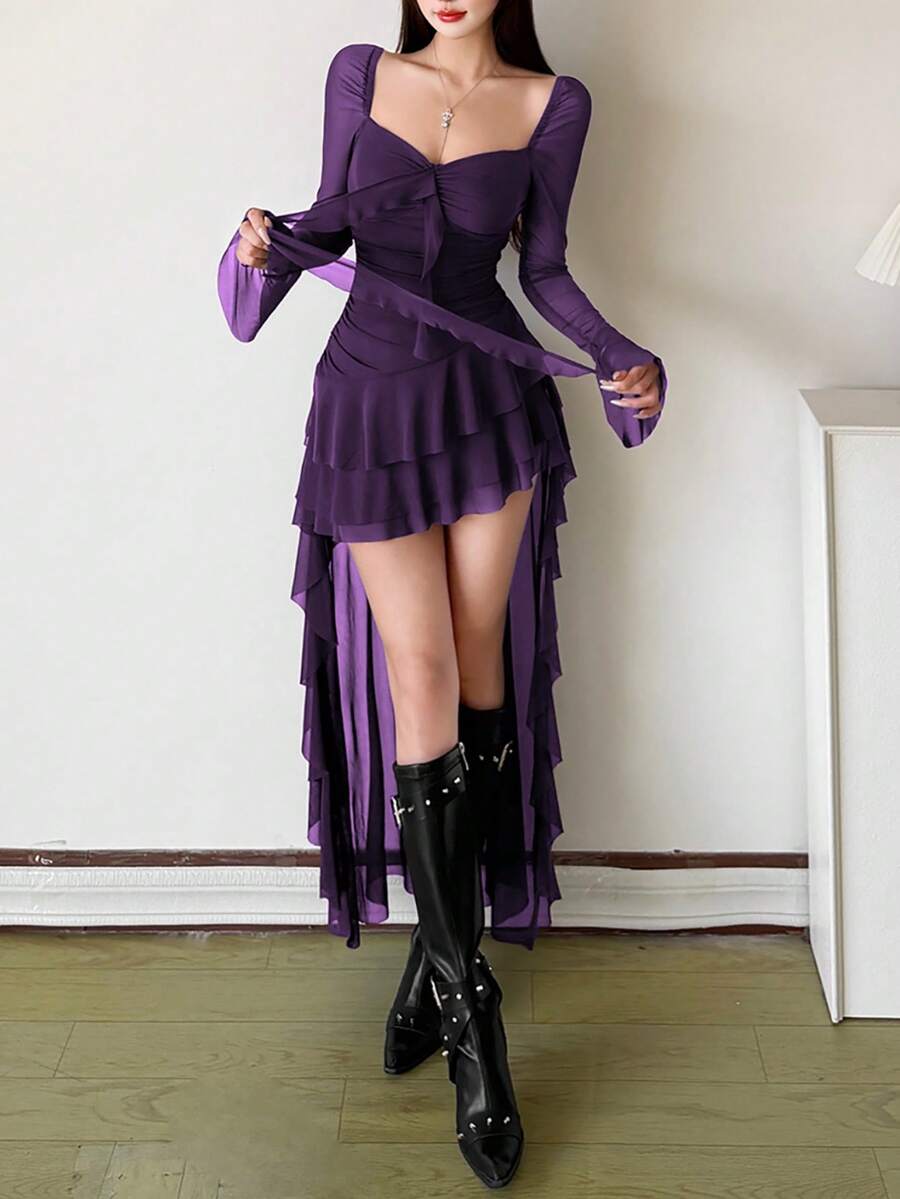 Woman wearing a solid off-the-shoulder asymmetrical midi dress with long flare sleeves.
