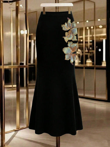 Women's black floral embroidered mermaid maxi skirt featuring high stretch fabric, skinny fit, and floor-length evening design.