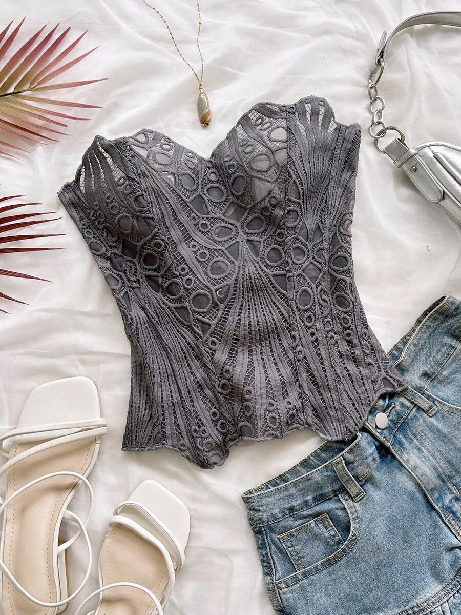Women’s strapless corset bustier top with lace-up detail, asymmetrical embroidery, semi-sheer finish, and slim fit.