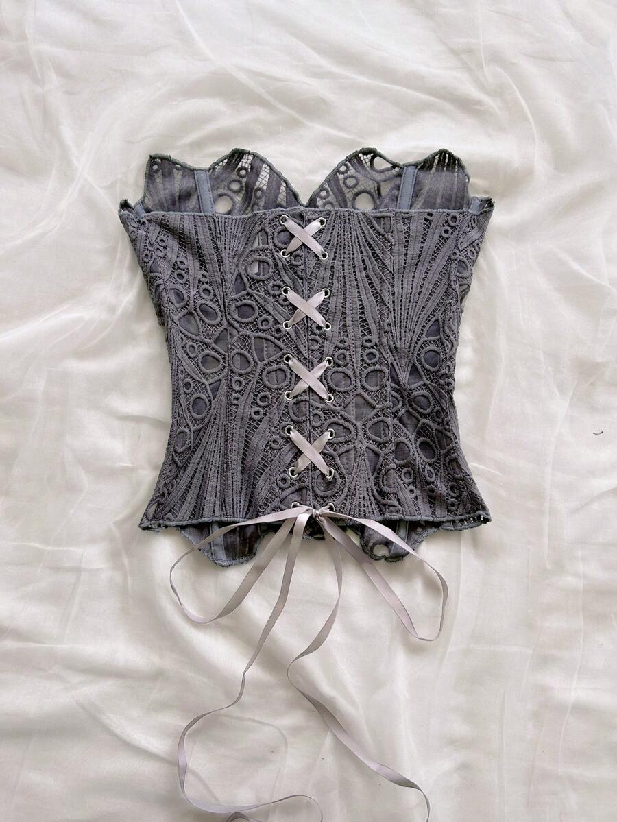 Women’s strapless corset bustier top with lace-up detail, asymmetrical embroidery, semi-sheer finish, and slim fit.