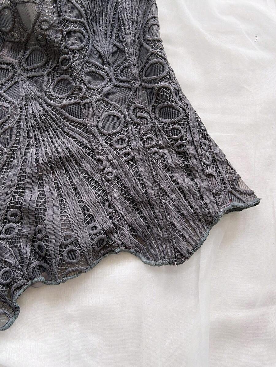Women’s strapless corset bustier top with lace-up detail, asymmetrical embroidery, semi-sheer finish, and slim fit.