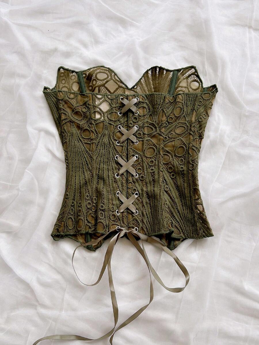 Women’s strapless corset bustier top with lace-up detail, asymmetrical embroidery, semi-sheer finish, and slim fit.