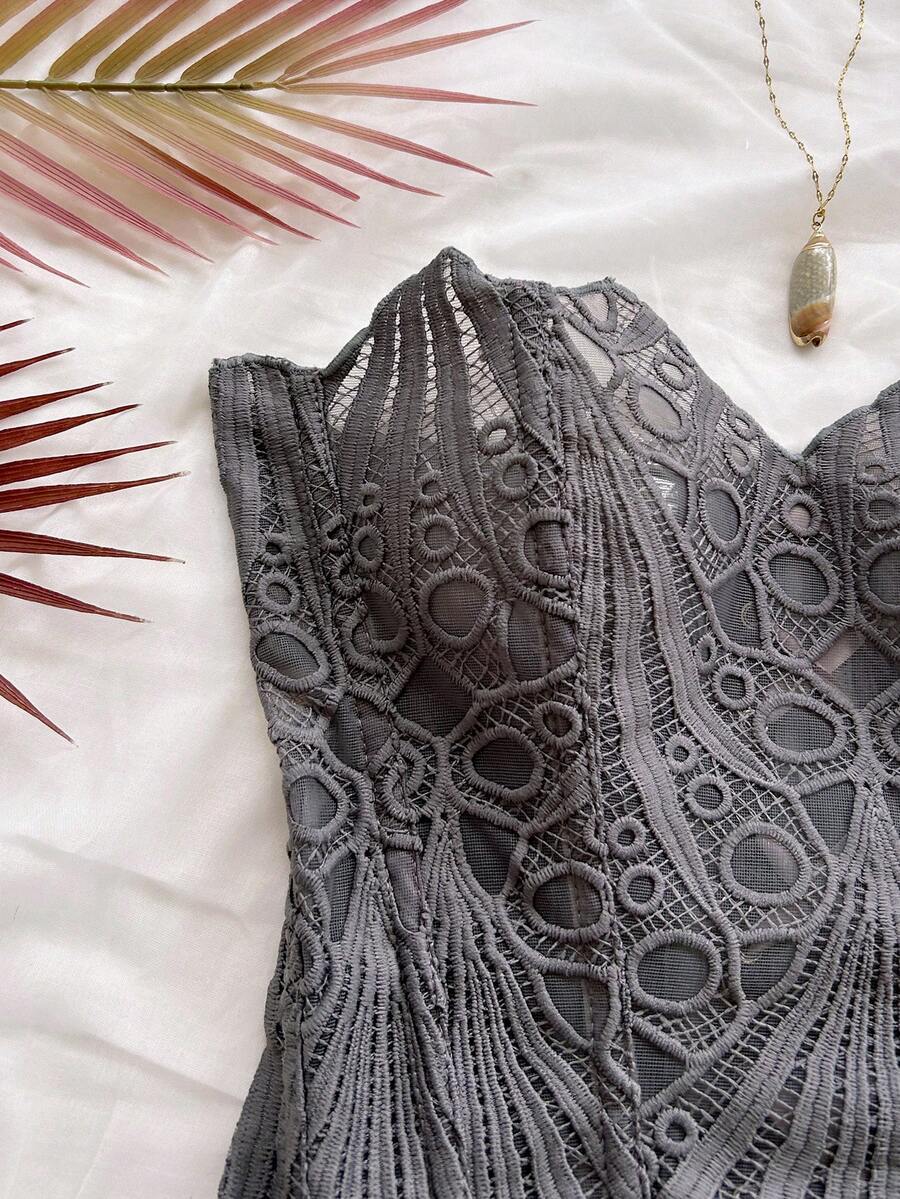 Women’s strapless corset bustier top with lace-up detail, asymmetrical embroidery, semi-sheer finish, and slim fit.