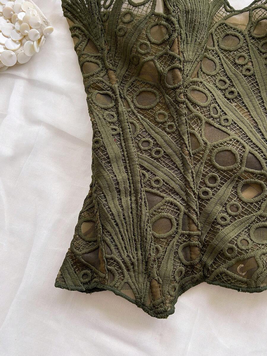 Women’s strapless corset bustier top with lace-up detail, asymmetrical embroidery, semi-sheer finish, and slim fit.