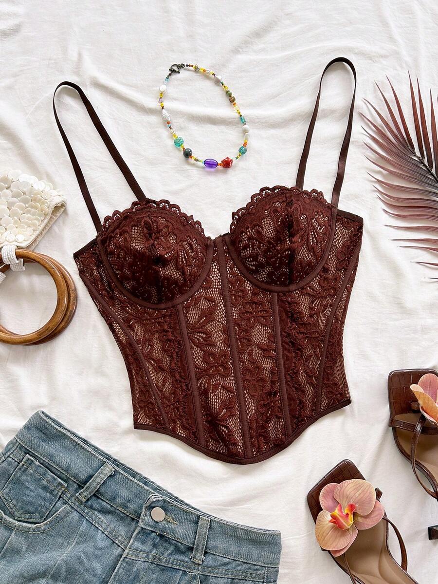 Women's lace bustier camisole top with spaghetti straps, contrast lace, lace-up detail, and an asymmetrical hem in a slim fit design.