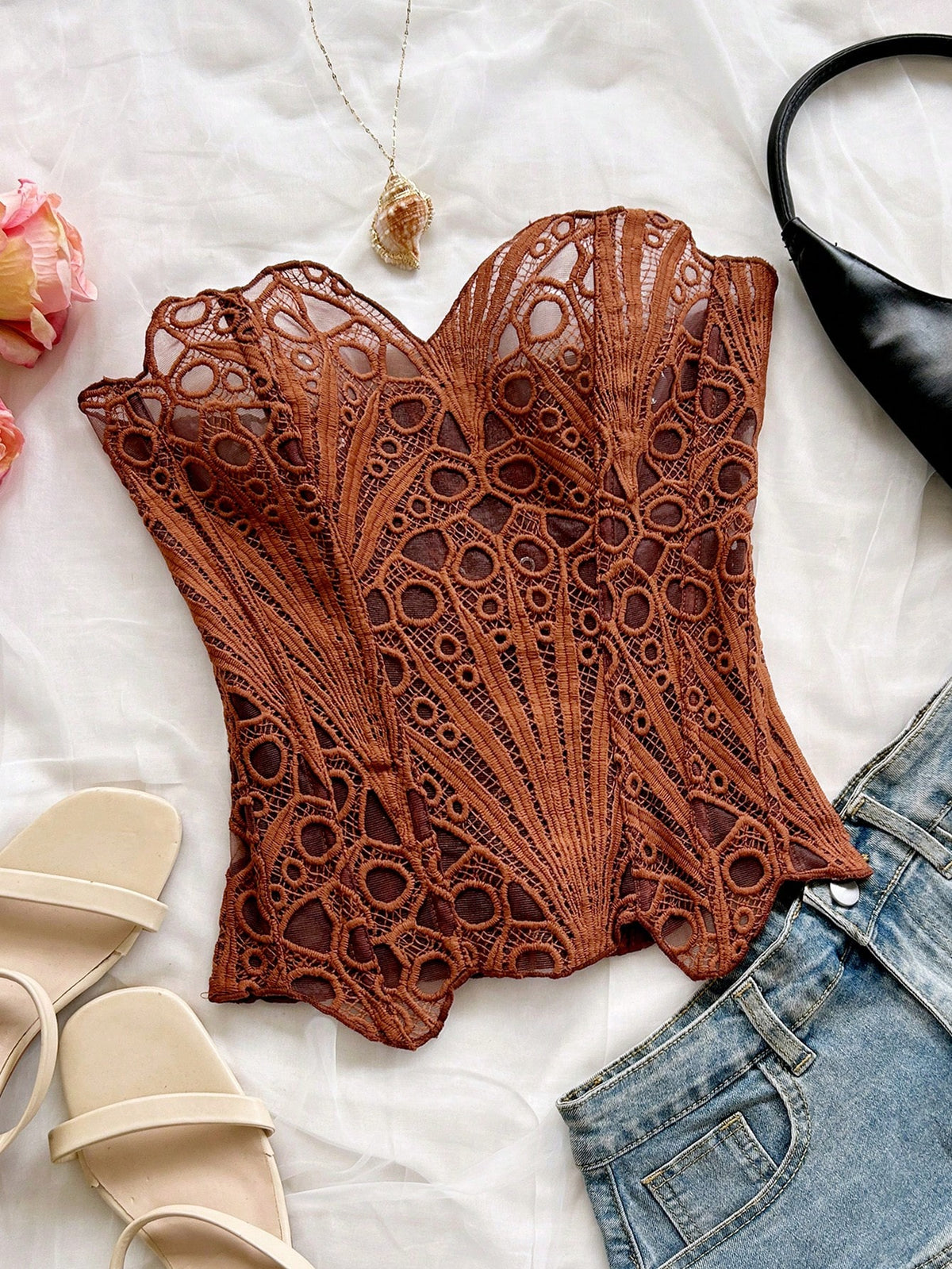 Women’s strapless corset bustier top with lace-up detail, asymmetrical embroidery, semi-sheer finish, and slim fit.