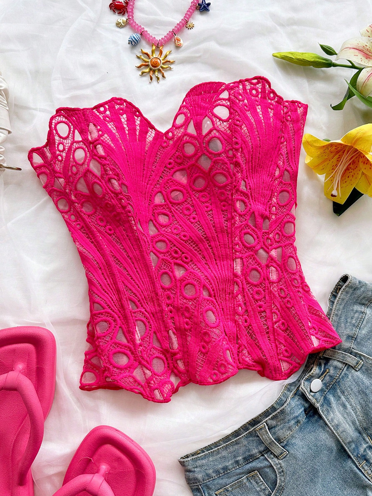 Women’s strapless corset bustier top with lace-up detail, asymmetrical embroidery, semi-sheer finish, and slim fit.