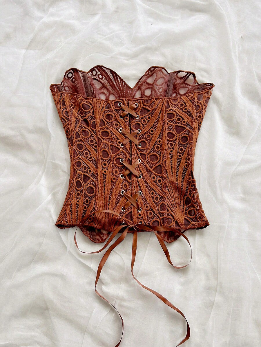 Women’s strapless corset bustier top with lace-up detail, asymmetrical embroidery, semi-sheer finish, and slim fit.