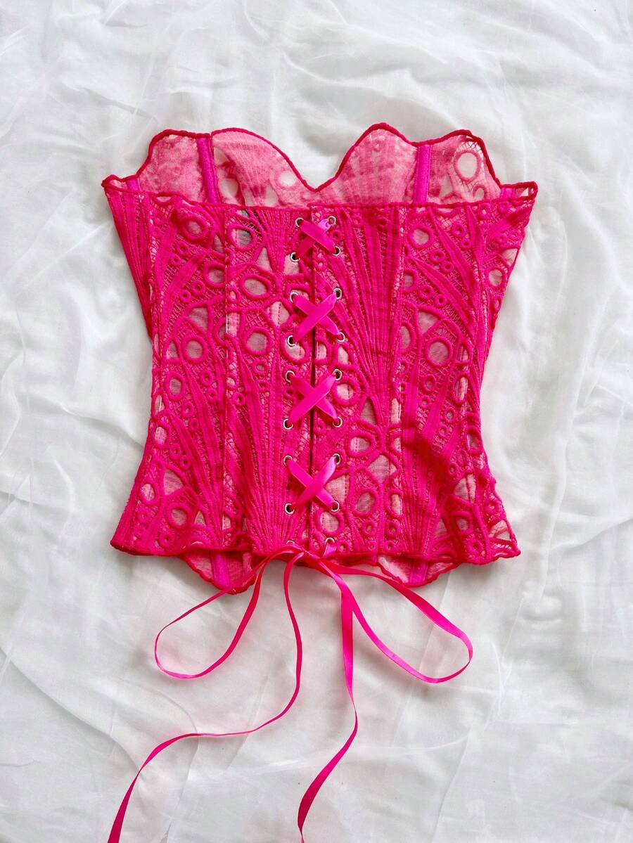 Women’s strapless corset bustier top with lace-up detail, asymmetrical embroidery, semi-sheer finish, and slim fit.