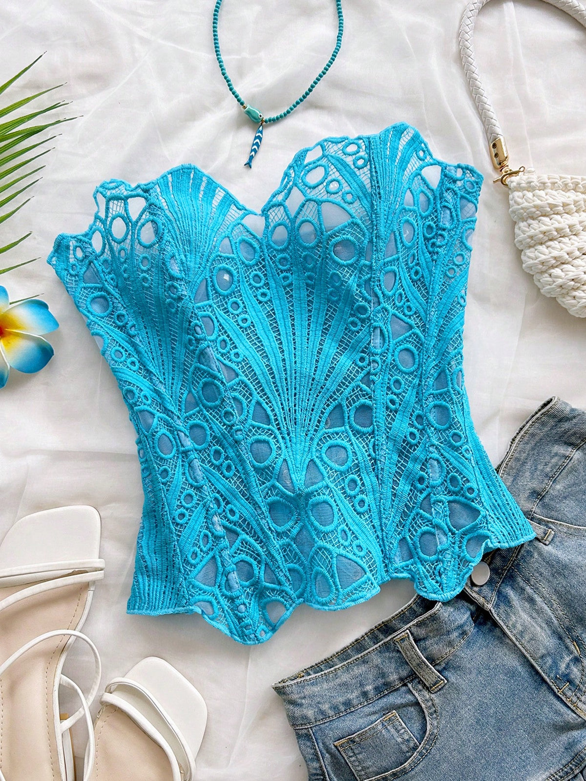 Women’s strapless corset bustier top with lace-up detail, asymmetrical embroidery, semi-sheer finish, and slim fit.