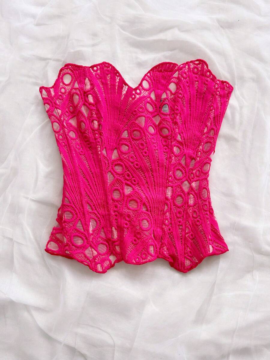 Women’s strapless corset bustier top with lace-up detail, asymmetrical embroidery, semi-sheer finish, and slim fit.