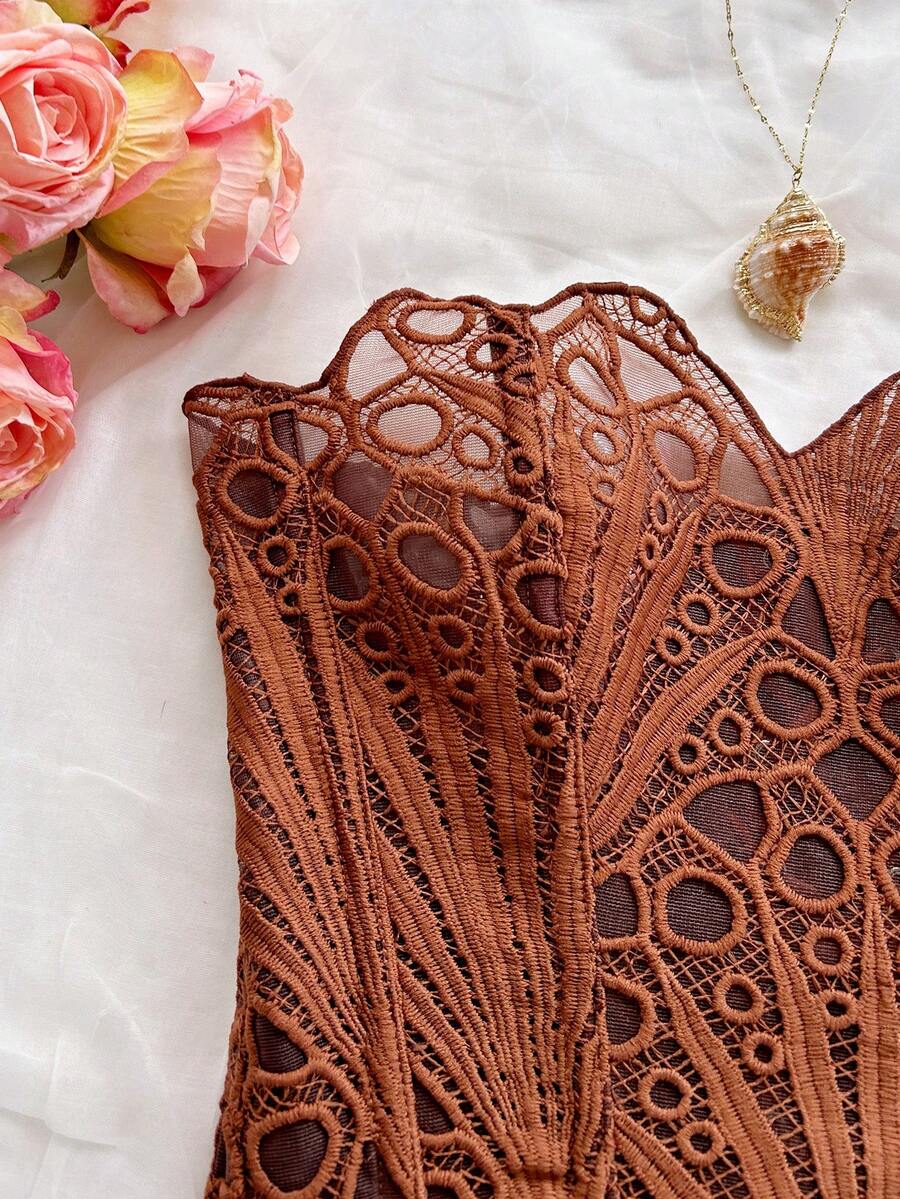 Women’s strapless corset bustier top with lace-up detail, asymmetrical embroidery, semi-sheer finish, and slim fit.