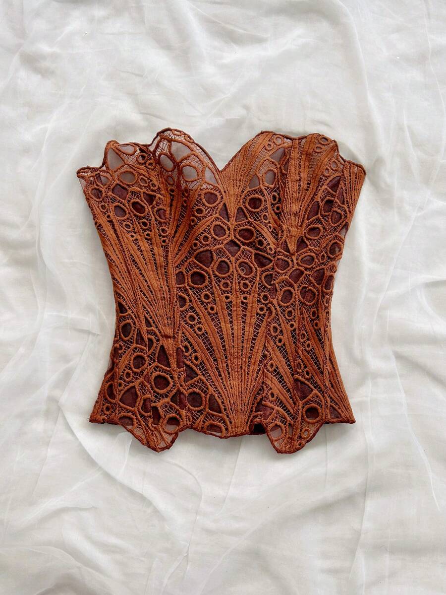 Women’s strapless corset bustier top with lace-up detail, asymmetrical embroidery, semi-sheer finish, and slim fit.