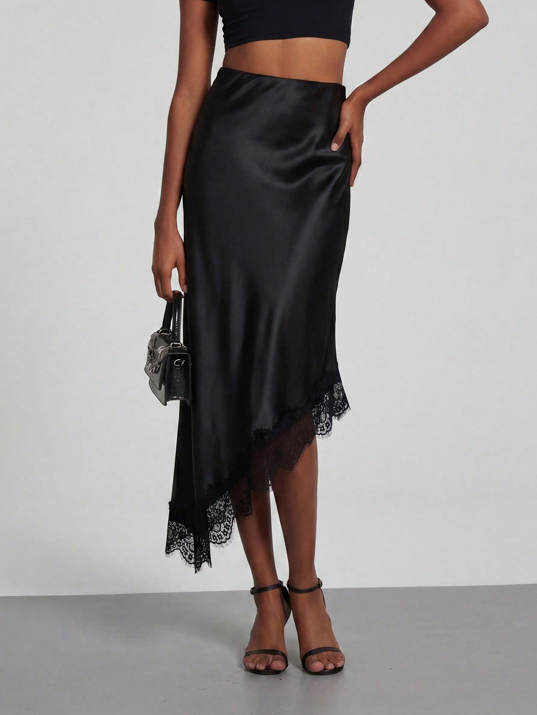 Black lace patchwork satin asymmetrical long skirt for women featuring a mid-waist loose fit design.