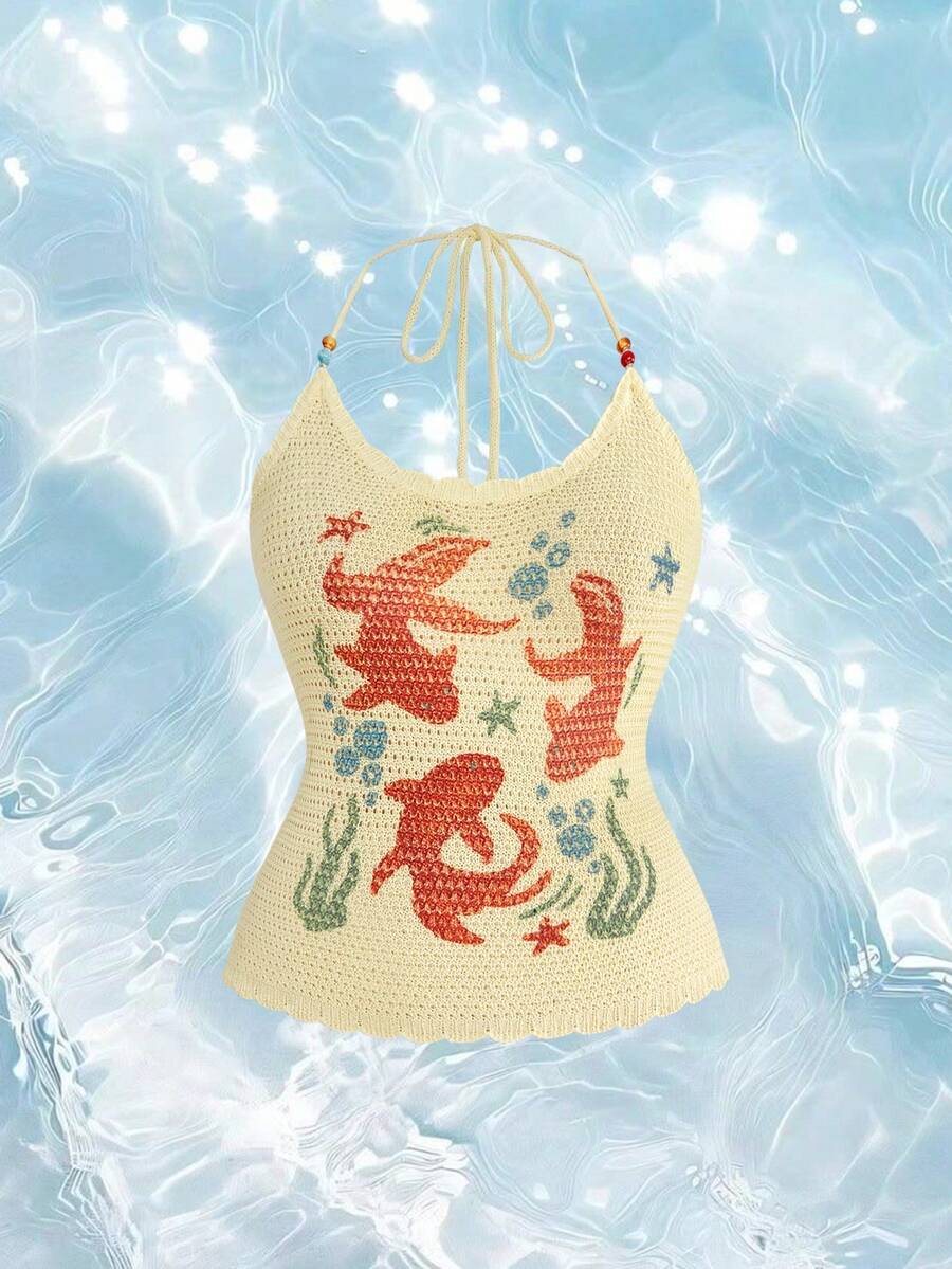 Light yellow halter cami top featuring a goldfish doodle graphic print with backless knot tie back detail.