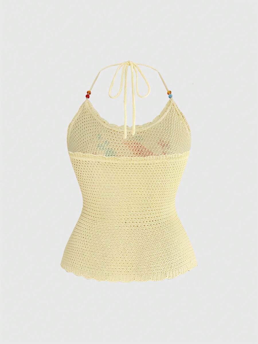 Light yellow halter cami top featuring a goldfish doodle graphic print with backless knot tie back detail.