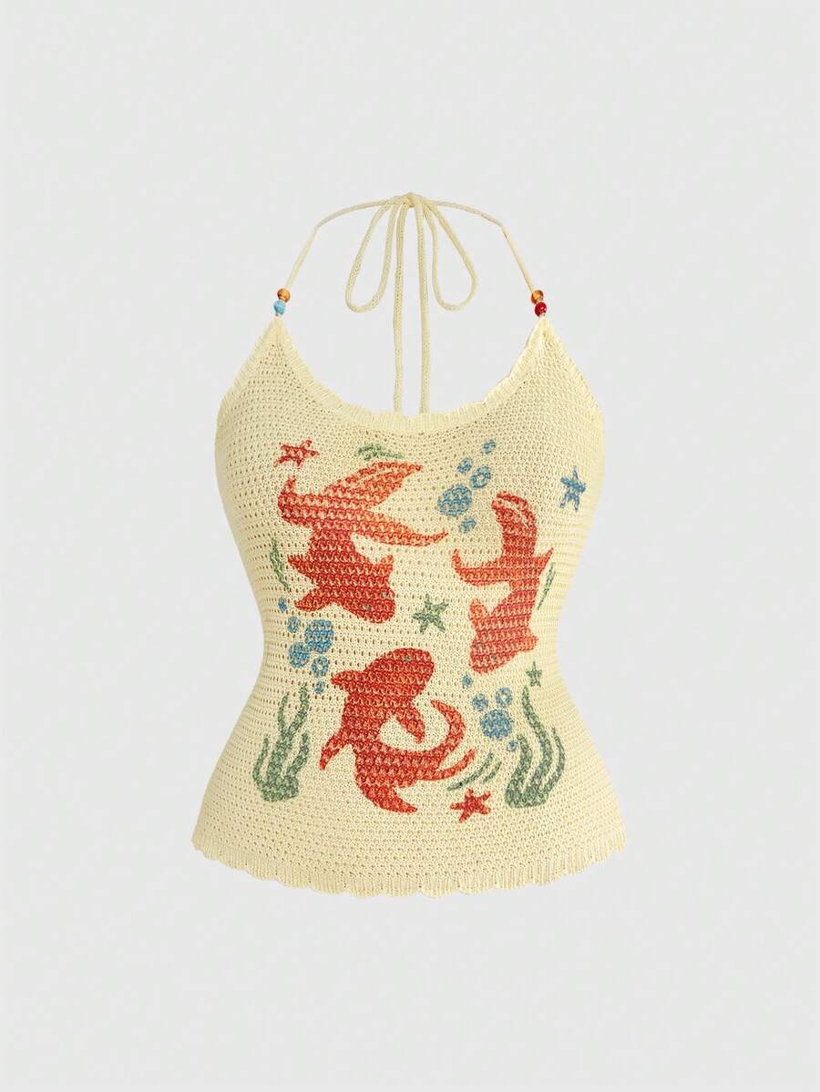 Light yellow halter cami top featuring a goldfish doodle graphic print with backless knot tie back detail.