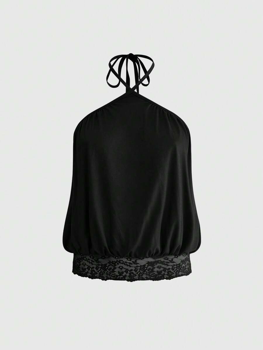 Woman wearing a black slim fit halter camisole crop top with lace-up backless tie detail.
