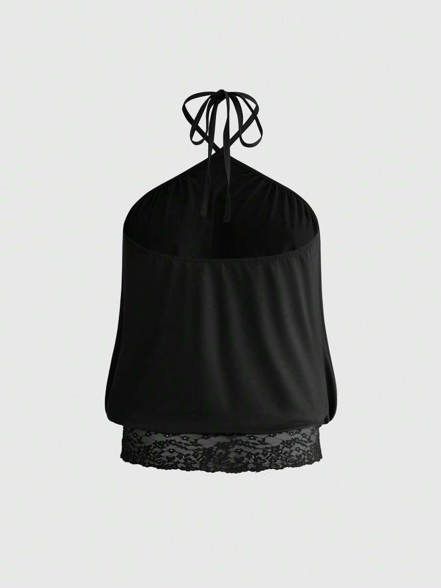 Woman wearing a black slim fit halter camisole crop top with lace-up backless tie detail.