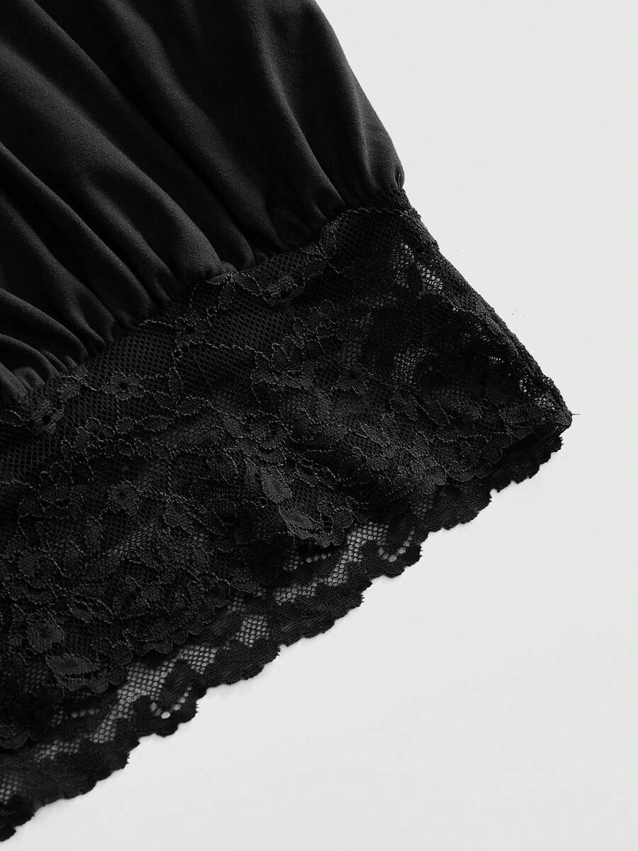 Woman wearing a black slim fit halter camisole crop top with lace-up backless tie detail.