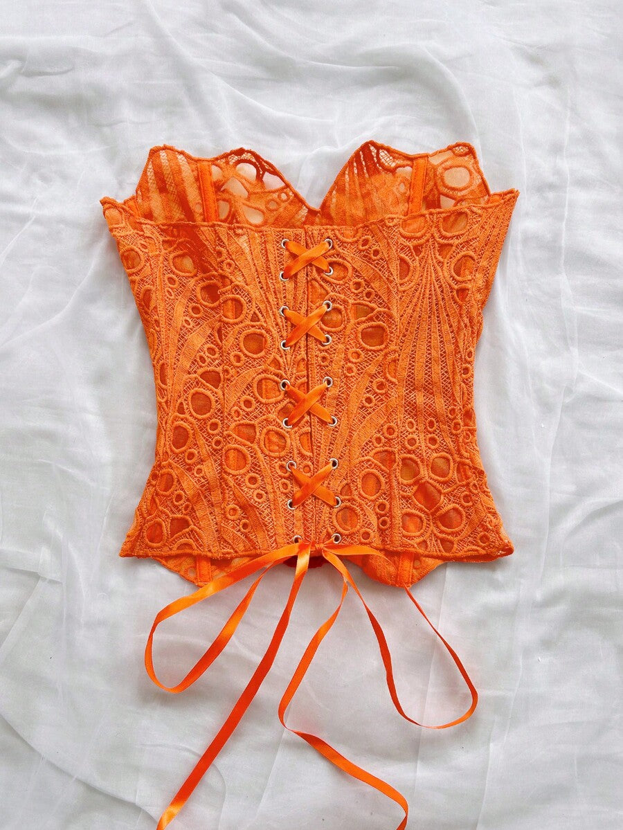 Women’s strapless corset bustier top with lace-up detail, asymmetrical embroidery, semi-sheer finish, and slim fit.
