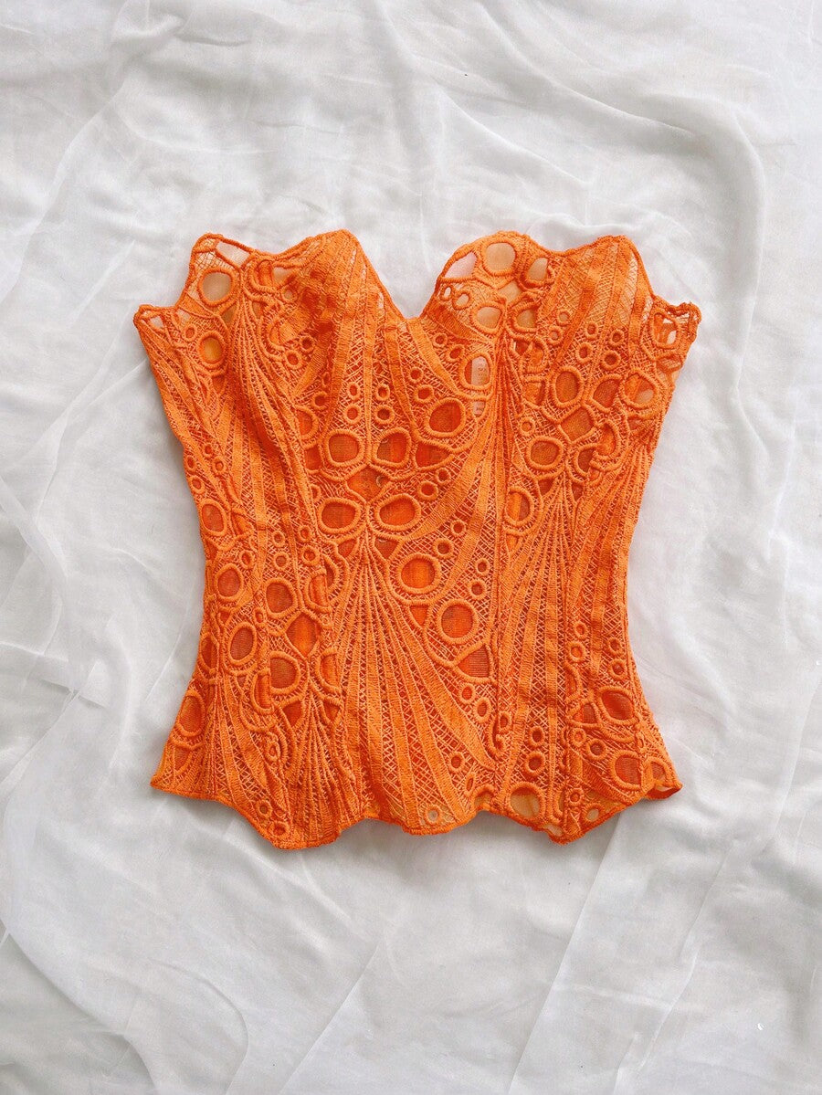 Women’s strapless corset bustier top with lace-up detail, asymmetrical embroidery, semi-sheer finish, and slim fit.