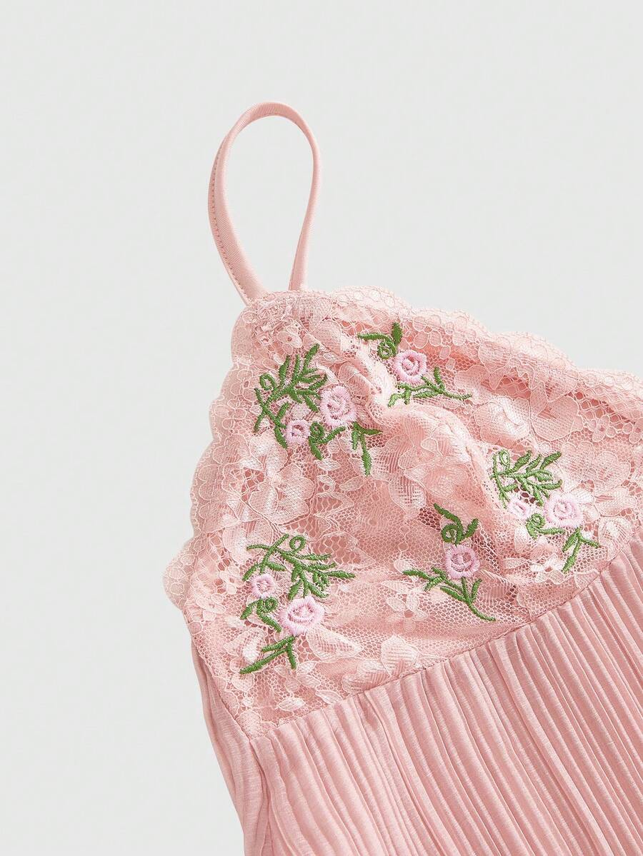 Pink lace embroidered spaghetti strap camisole top for women featuring backless design and slim fit silhouette.