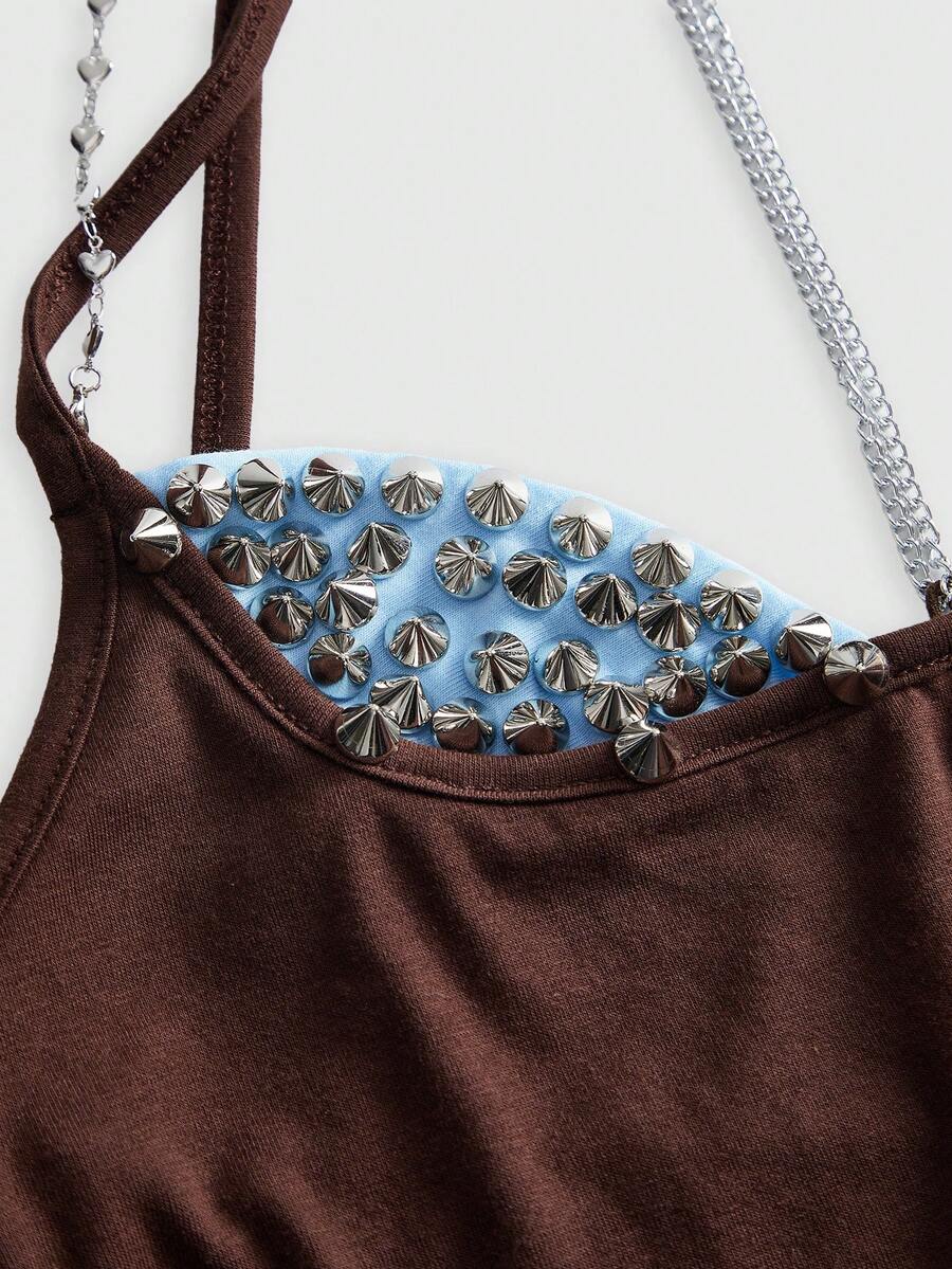 Women's black halter backless crop top with criss cross knot design and spaghetti straps.