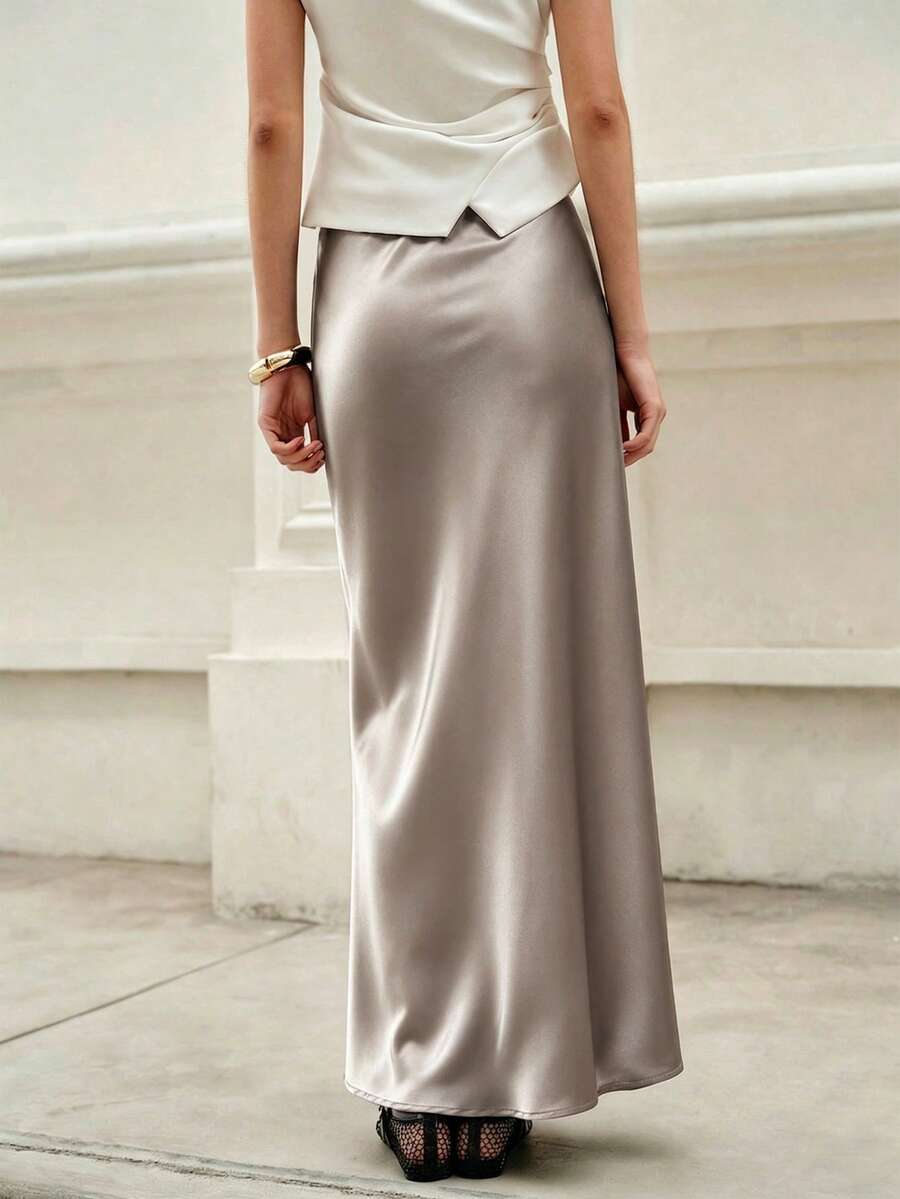 Elegant plain black mid waist long satin skirt for women featuring a sleek zipper closure and regular fit.