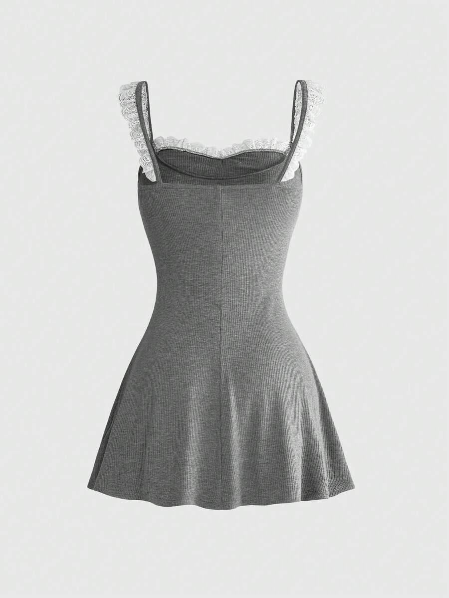 Women's sleeveless black colorblock cami mini dress with shoulder straps, frill detailing, slim fit waist, and flared hem.