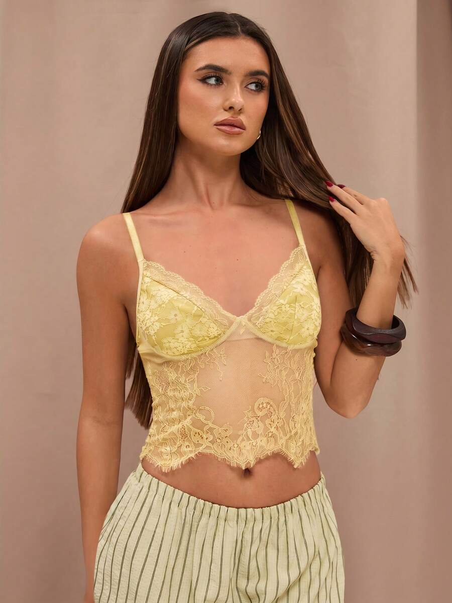 Black floral lace cropped camisole top for women featuring delicate spaghetti straps, cup detail, and semi-sheer contrast lace.