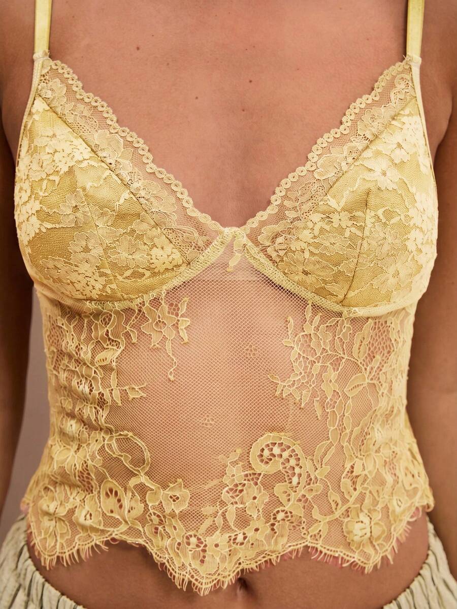 Black floral lace cropped camisole top for women featuring delicate spaghetti straps, cup detail, and semi-sheer contrast lace.