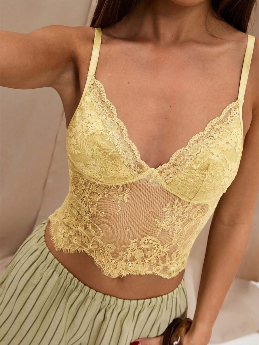 Black floral lace cropped camisole top for women featuring delicate spaghetti straps, cup detail, and semi-sheer contrast lace.