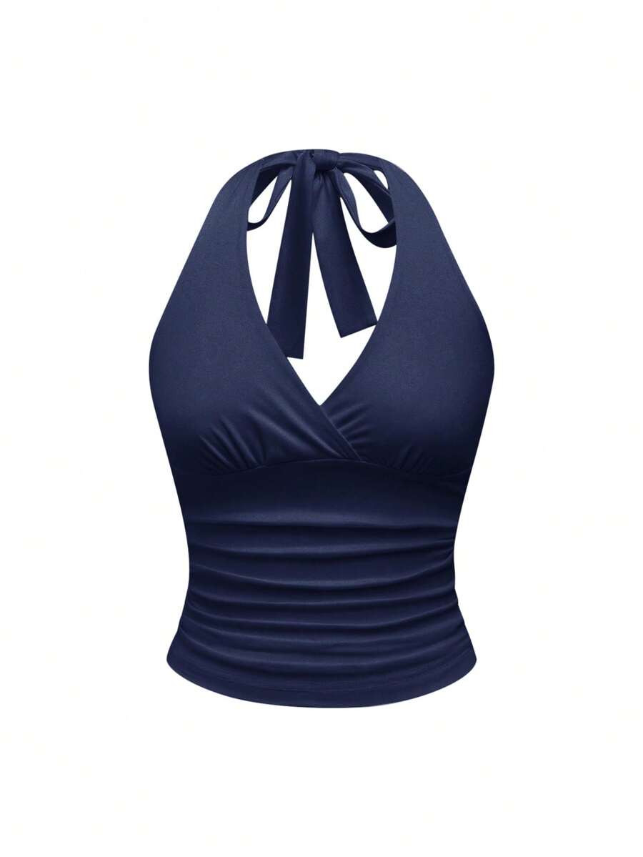 Women's halter crop tank top featuring a backless silhouette and ruched detailing in a slim fit design.