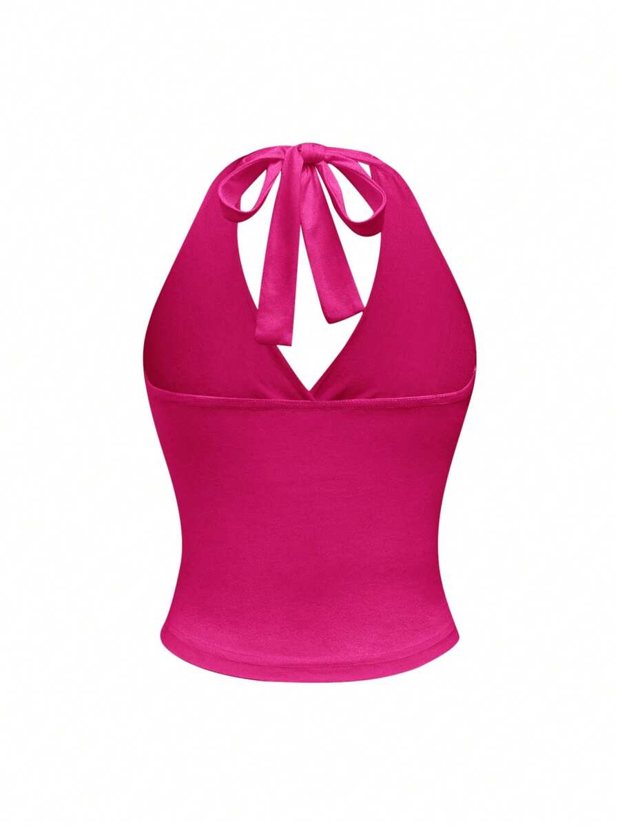 Women's halter crop tank top featuring a backless silhouette and ruched detailing in a slim fit design.