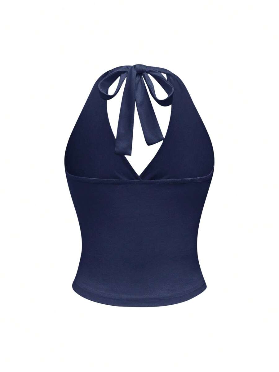 Women's halter crop tank top featuring a backless silhouette and ruched detailing in a slim fit design.