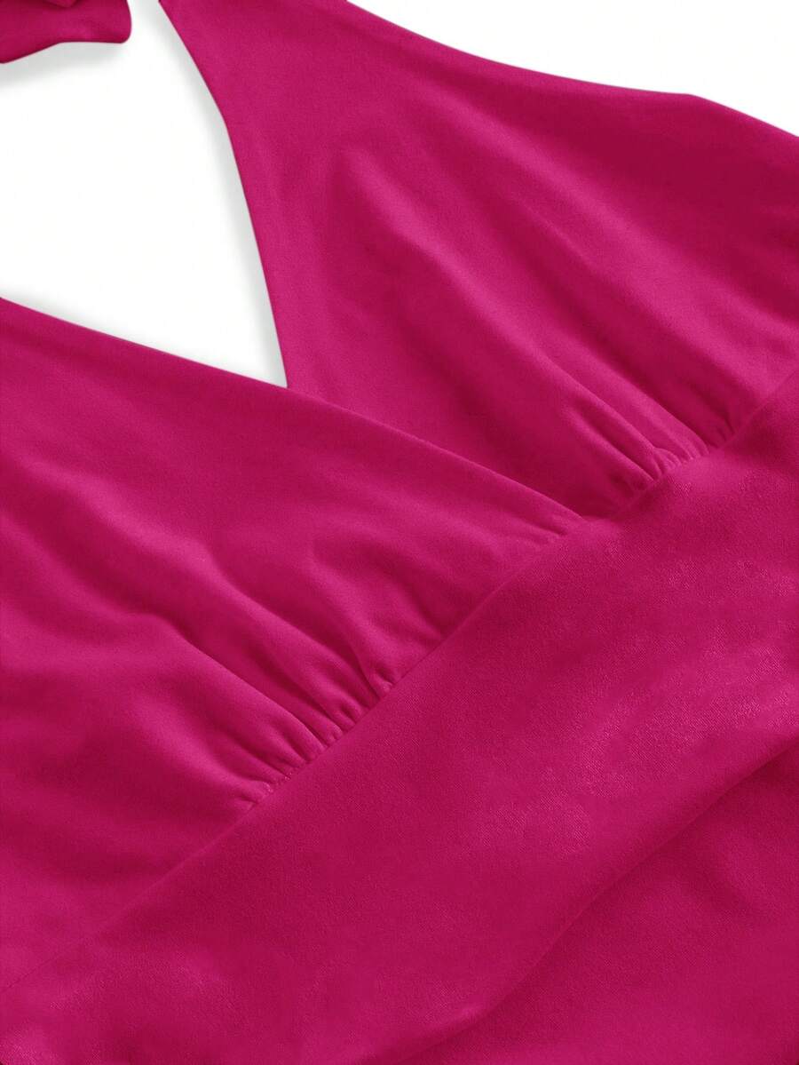 Women's halter crop tank top featuring a backless silhouette and ruched detailing in a slim fit design.