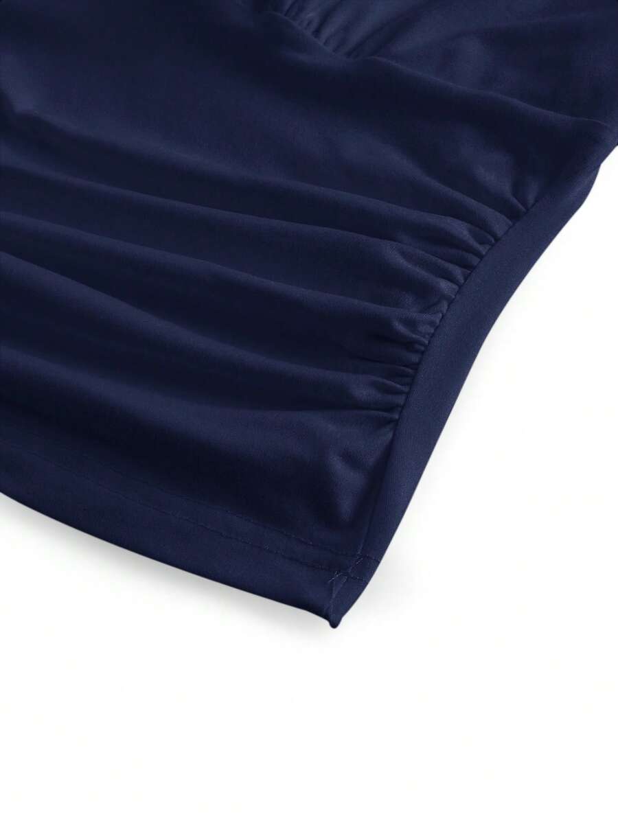 Women's halter crop tank top featuring a backless silhouette and ruched detailing in a slim fit design.
