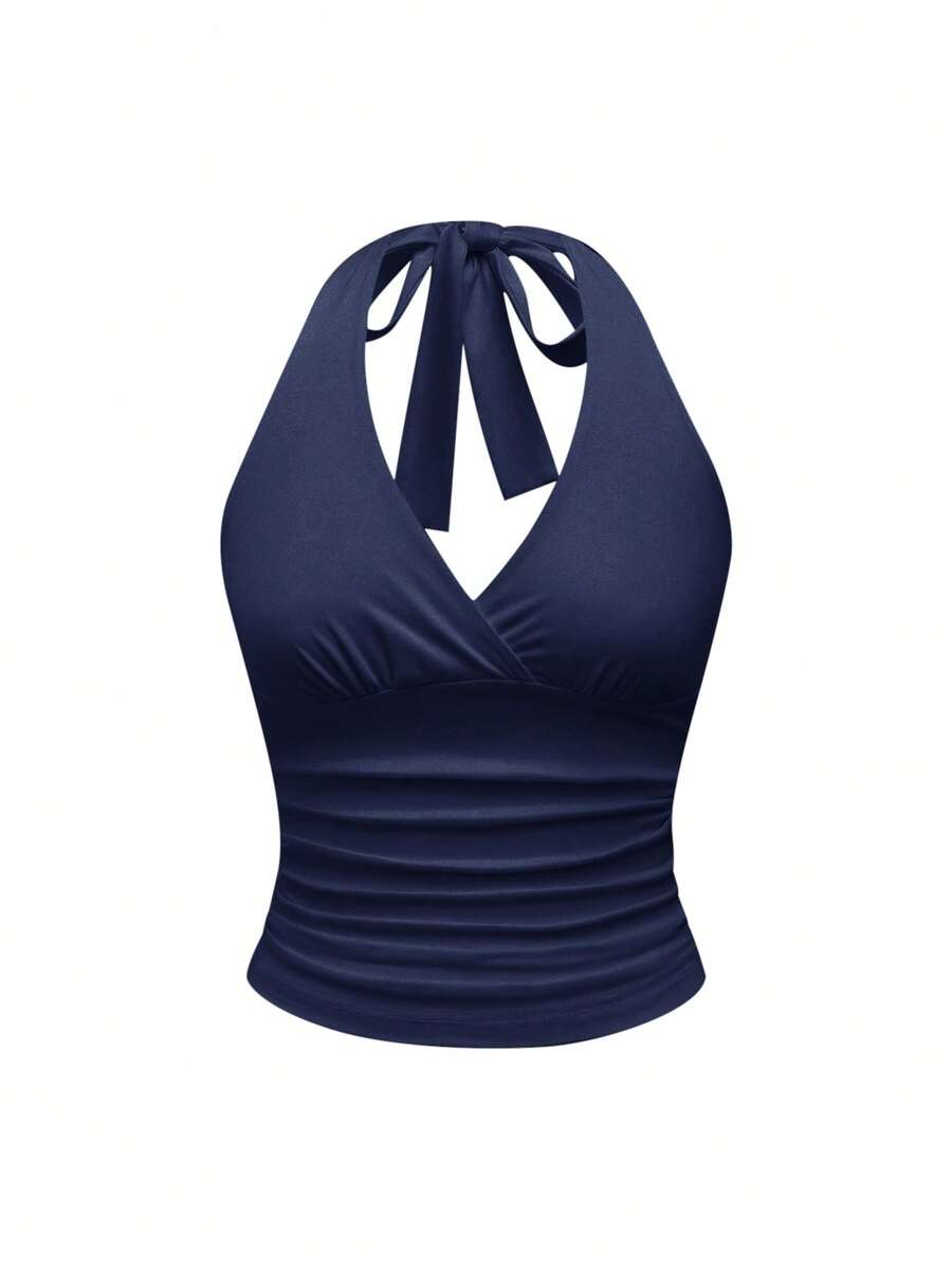 Women's halter crop tank top featuring a backless silhouette and ruched detailing in a slim fit design.
