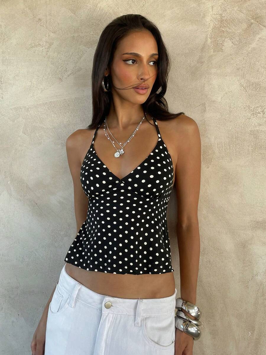 Women's black faux leather backless cami top with spaghetti straps and lace-up shirred sides.