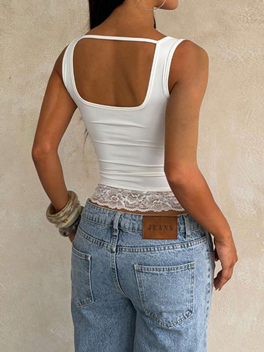 Women's white sleeveless crop top with contrast lace trim, shoulder straps, and a floral graphic print.