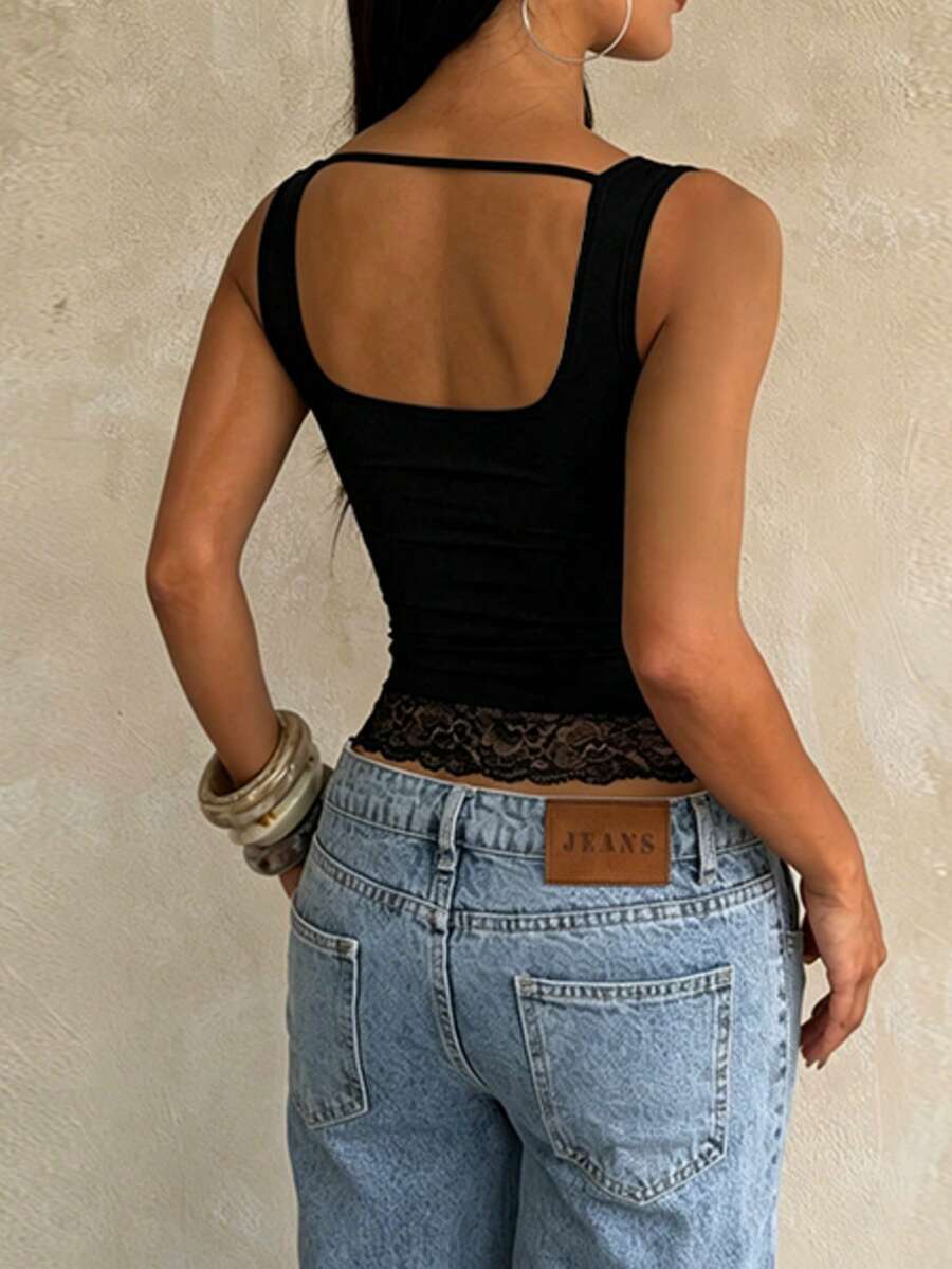 Women's white sleeveless crop top with contrast lace trim, shoulder straps, and a floral graphic print.
