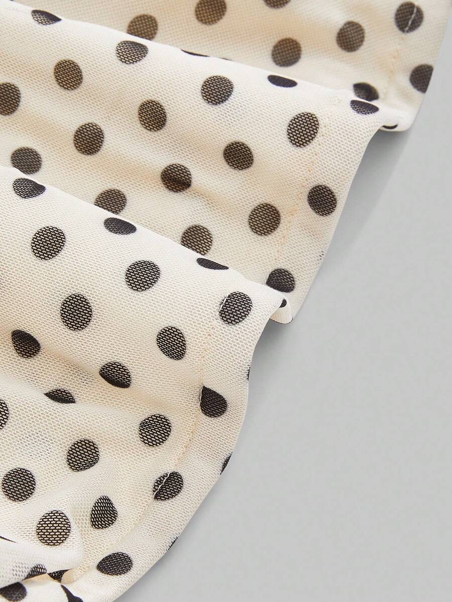 Women's black polka dot strapless tube top made of ruched mesh fabric featuring an asymmetrical hem and matching scarf.
