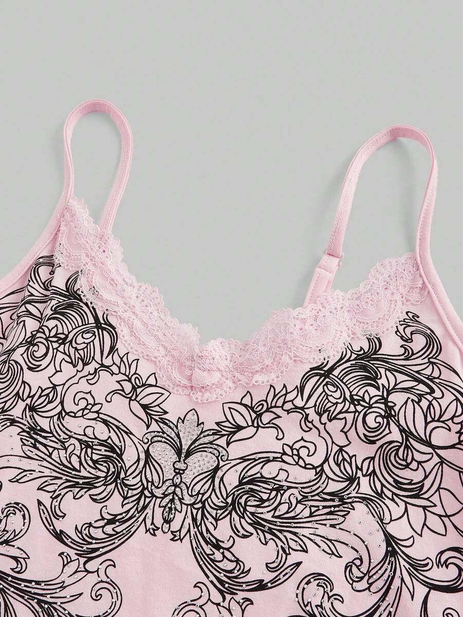 Pink floral print crop camisole top for women featuring contrast lace trim, spaghetti straps, and a slim fit.