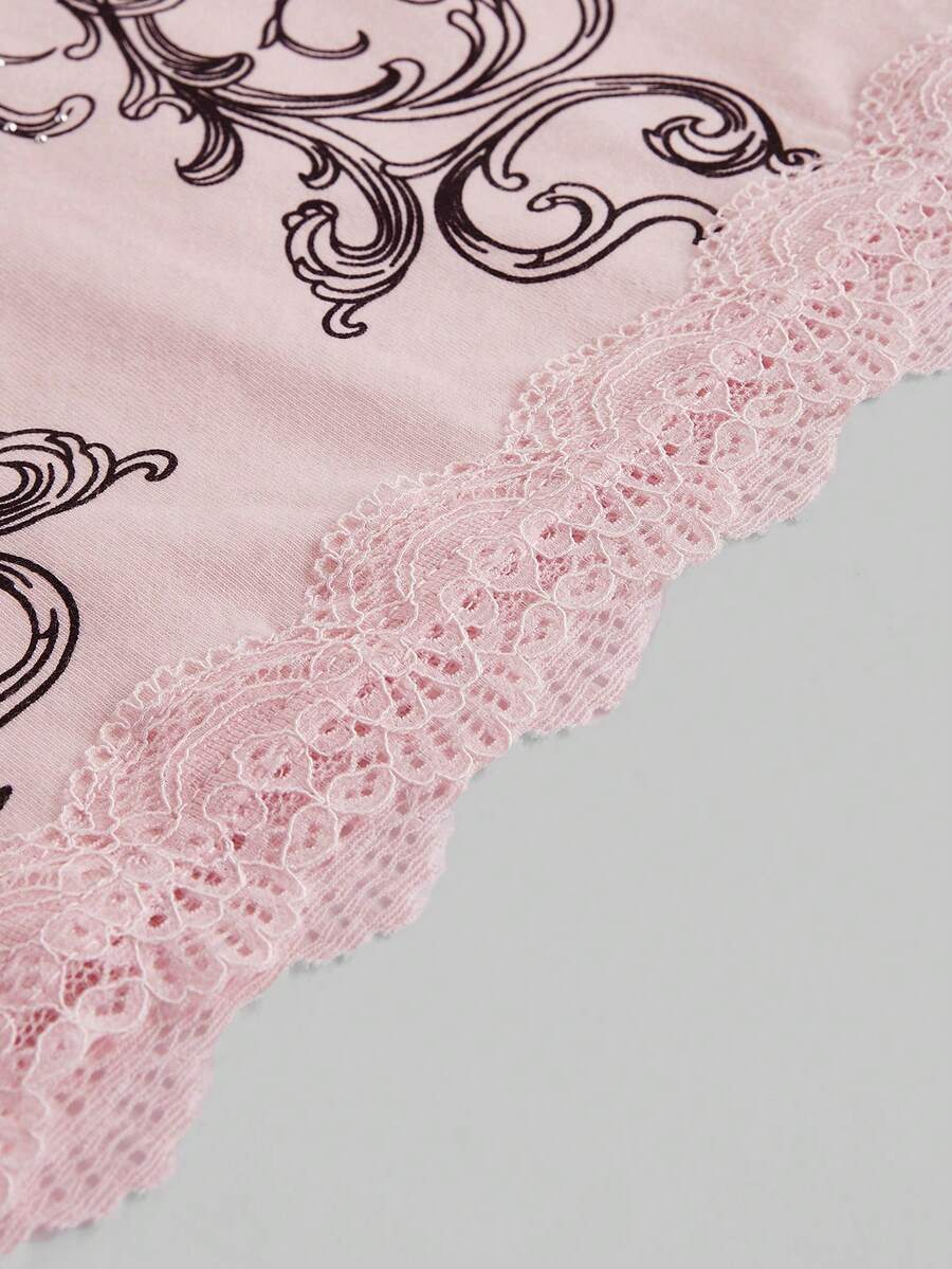Pink floral print crop camisole top for women featuring contrast lace trim, spaghetti straps, and a slim fit.