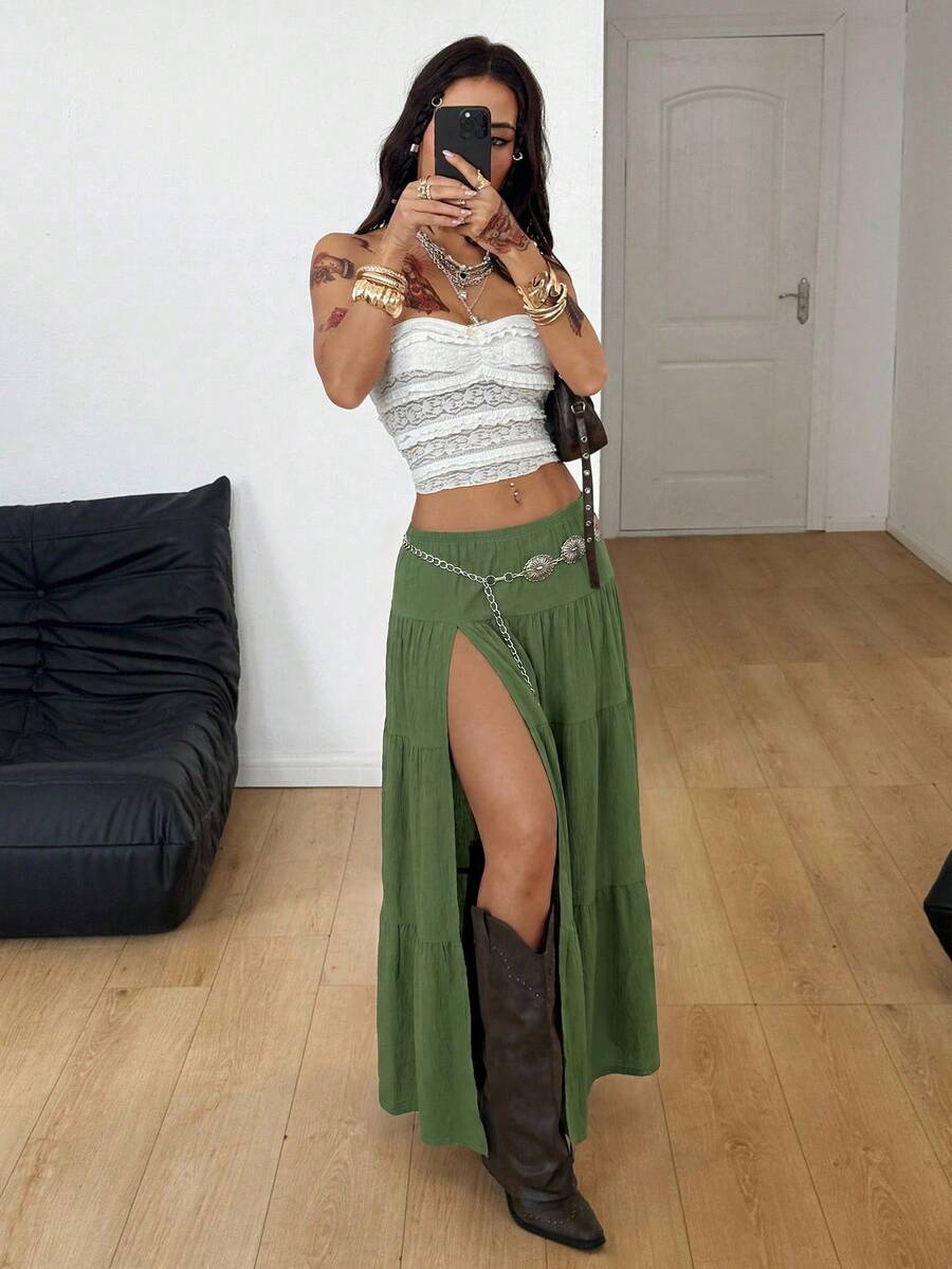 Women's black low waist split thigh long skirt featuring semi-sheer textured fabric and a flared skinny fit.