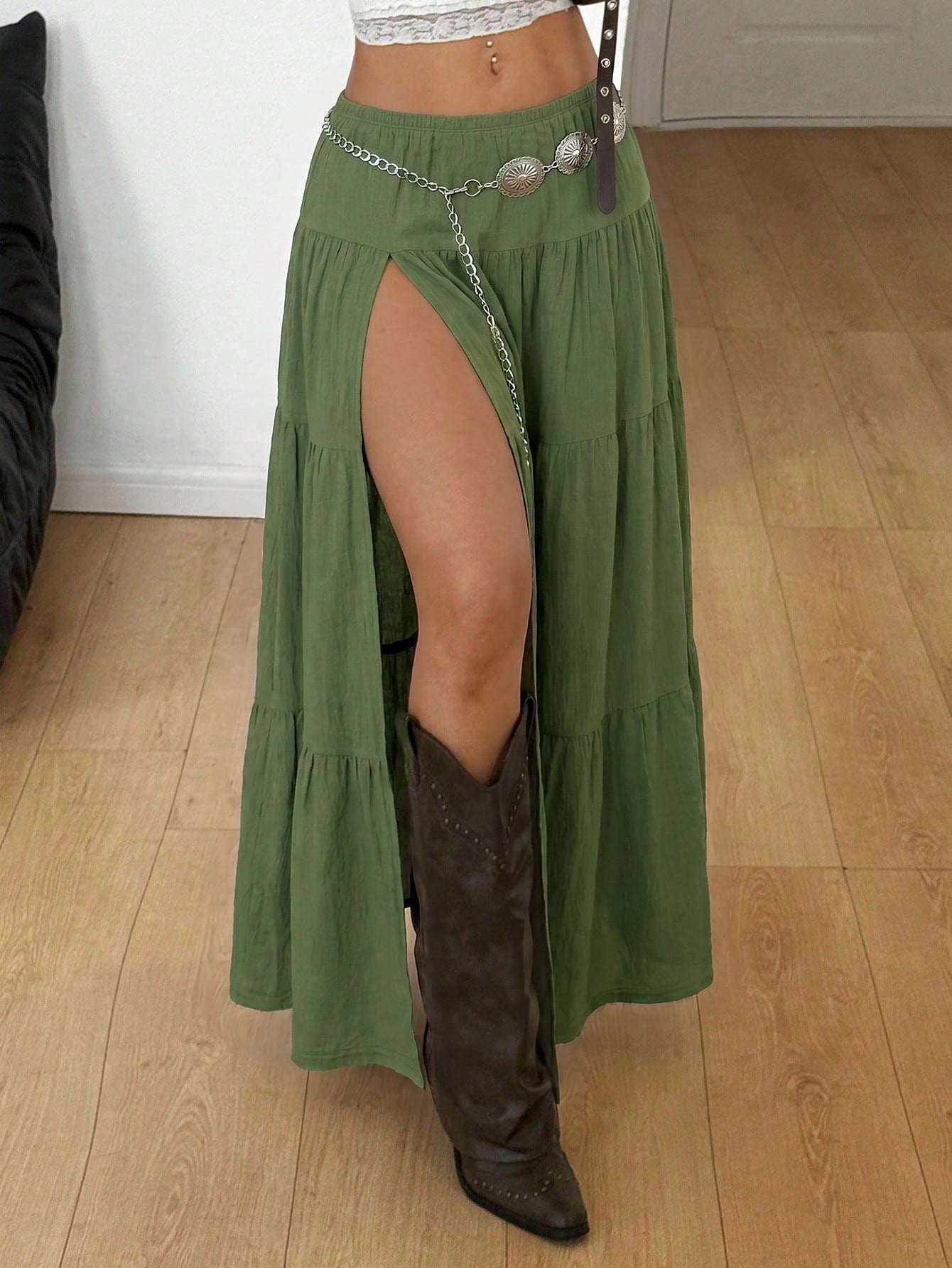 Women's black low waist split thigh long skirt featuring semi-sheer textured fabric and a flared skinny fit.
