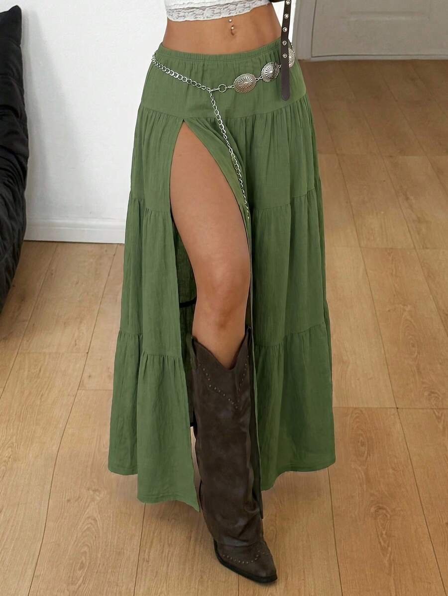 Women's black low waist split thigh long skirt featuring semi-sheer textured fabric and a flared skinny fit.