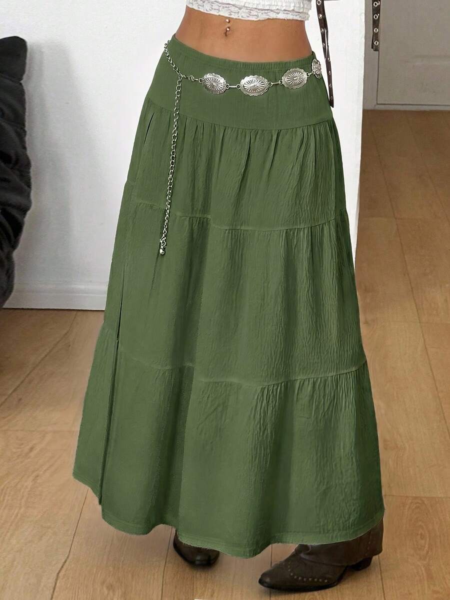 Women's black low waist split thigh long skirt featuring semi-sheer textured fabric and a flared skinny fit.