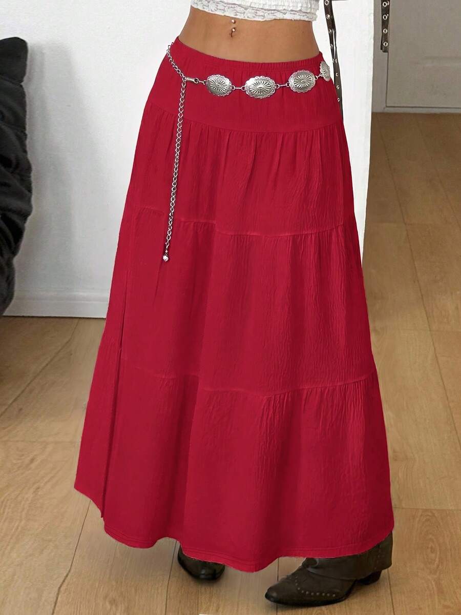 Women's black low waist split thigh long skirt featuring semi-sheer textured fabric and a flared skinny fit.